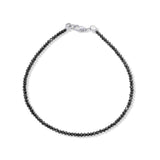 Black beaded bracelet with silver clasp on a white background