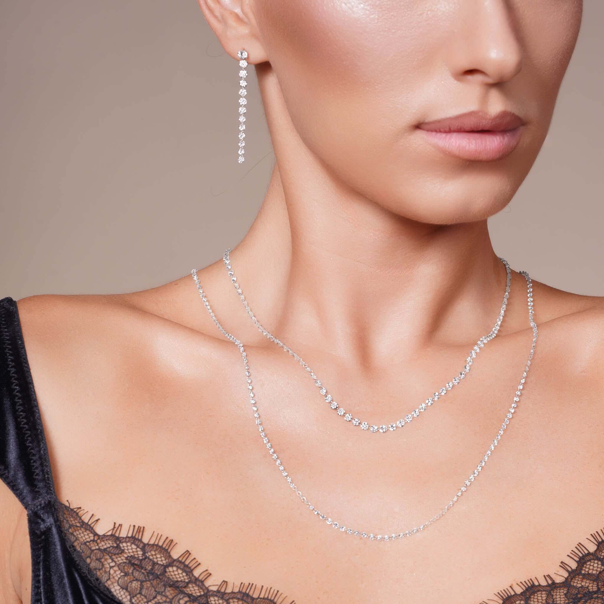 Model showcasing 24.8 Carat Floating Lab Diamond Necklace with layered diamonds and elegant earrings.