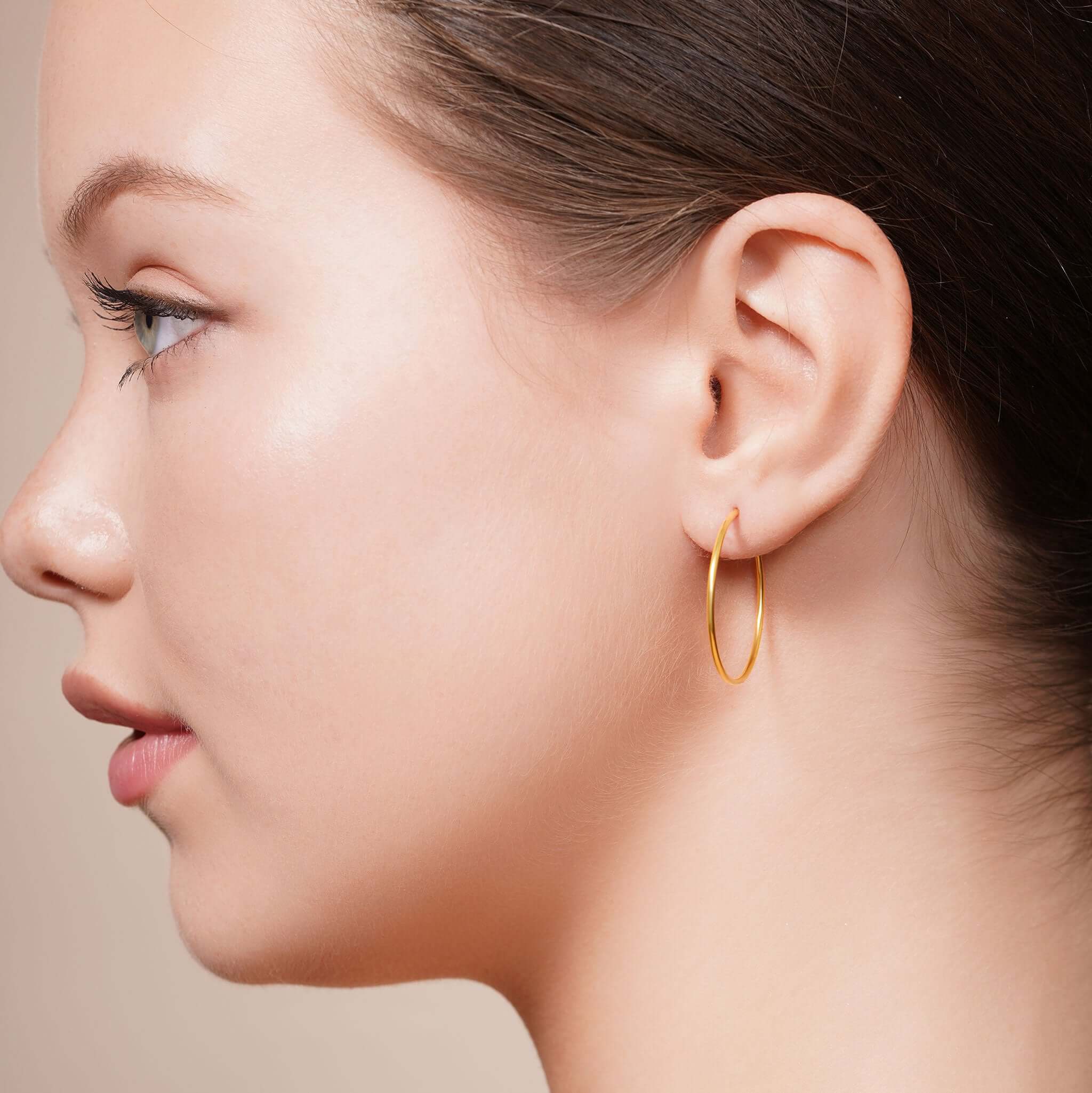 Model showcasing Gold Endless Hoop Earrings for timeless elegance and everyday style.