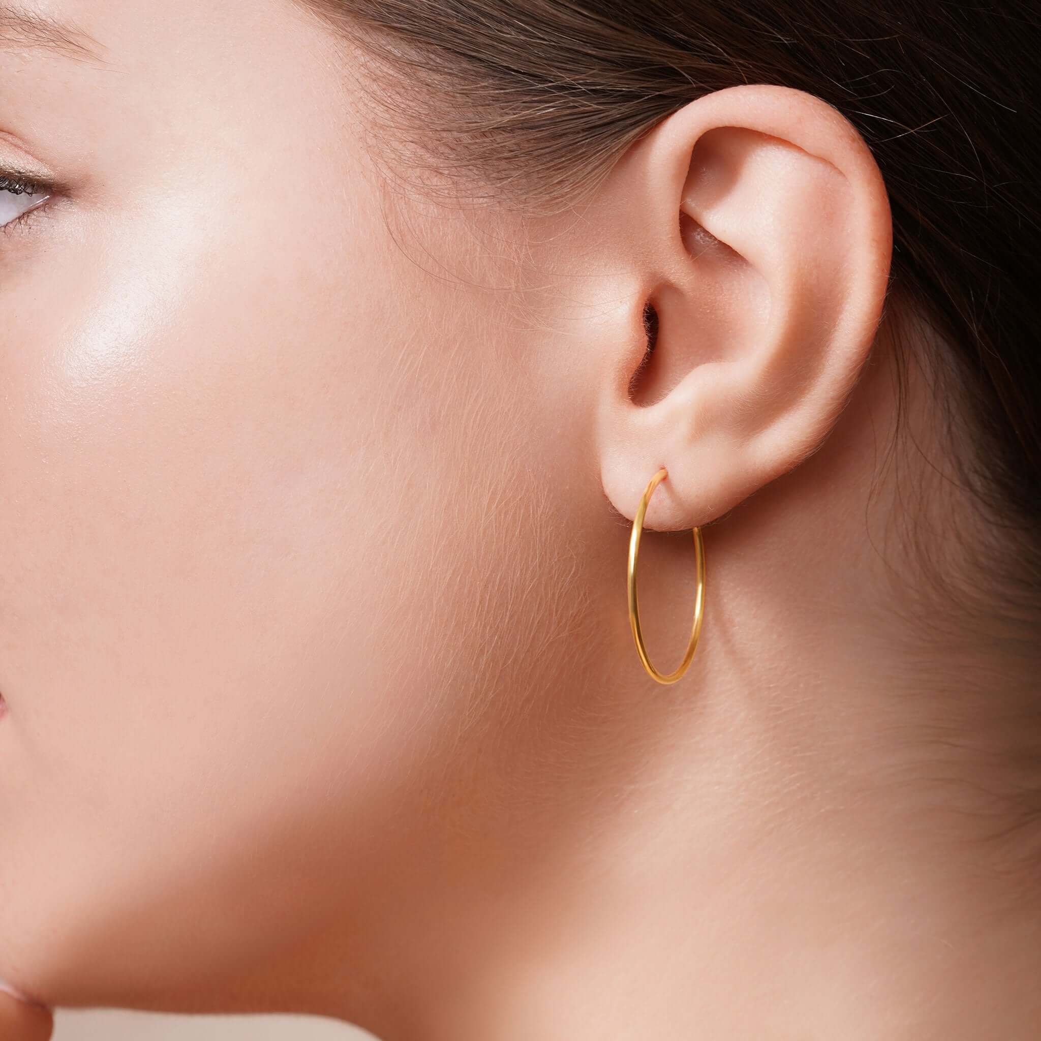 Gold Endless Hoop Earrings worn by a model, showcasing timeless elegance and seamless design.