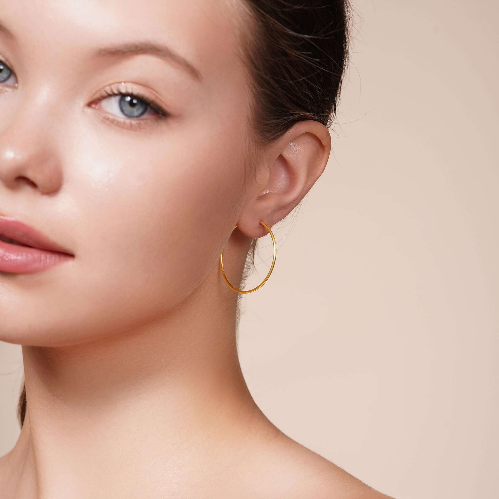 Model showcasing Gold Endless Hoop Earrings, highlighting timeless design and elegant style.
