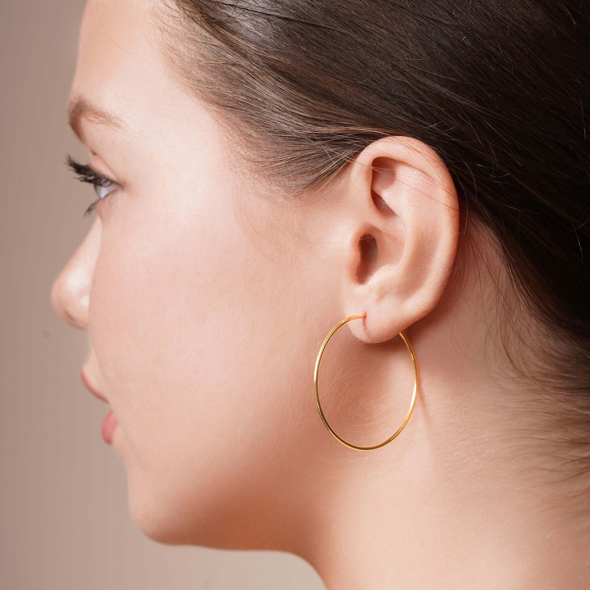 Model showcasing Gold Endless Hoop Earrings, highlighting their timeless design and elegant look.
