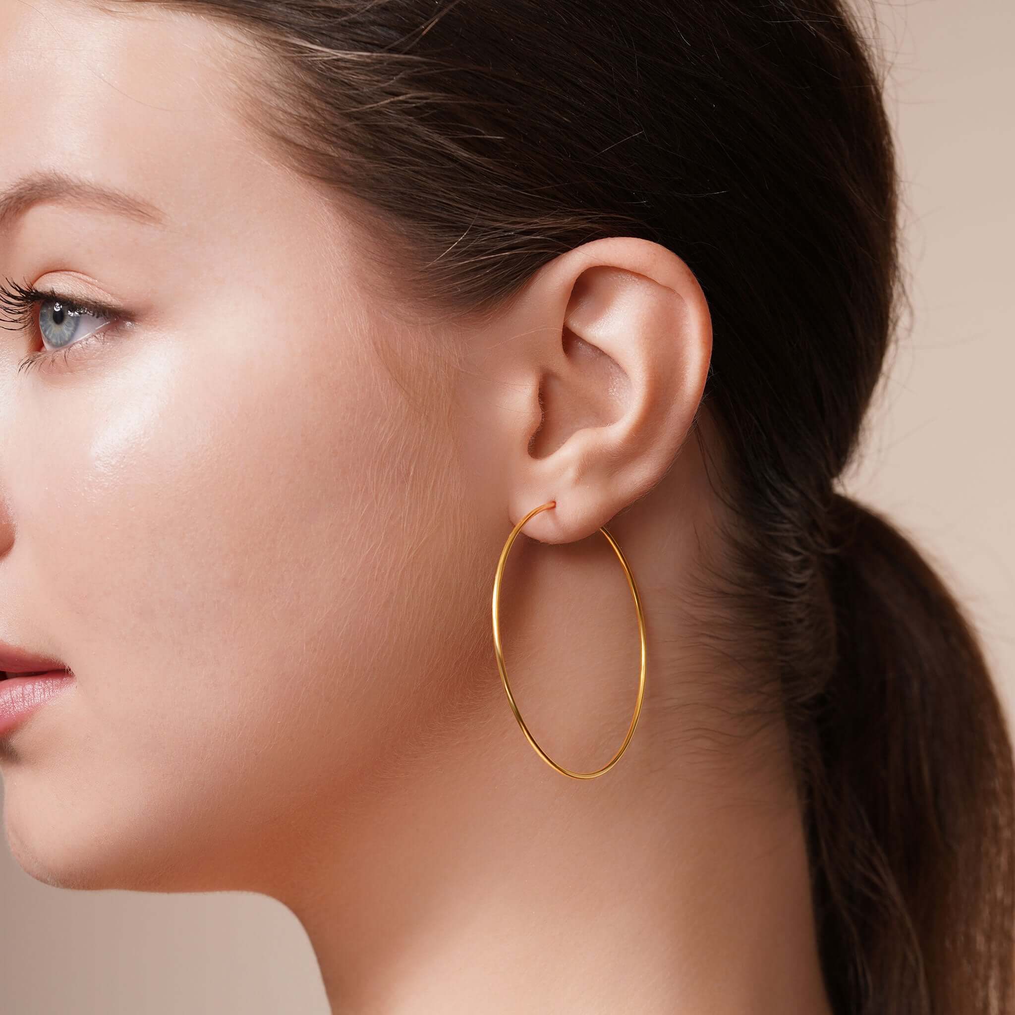Model wearing Gold Endless Hoop Earrings, featuring a sleek and timeless design for everyday elegance.