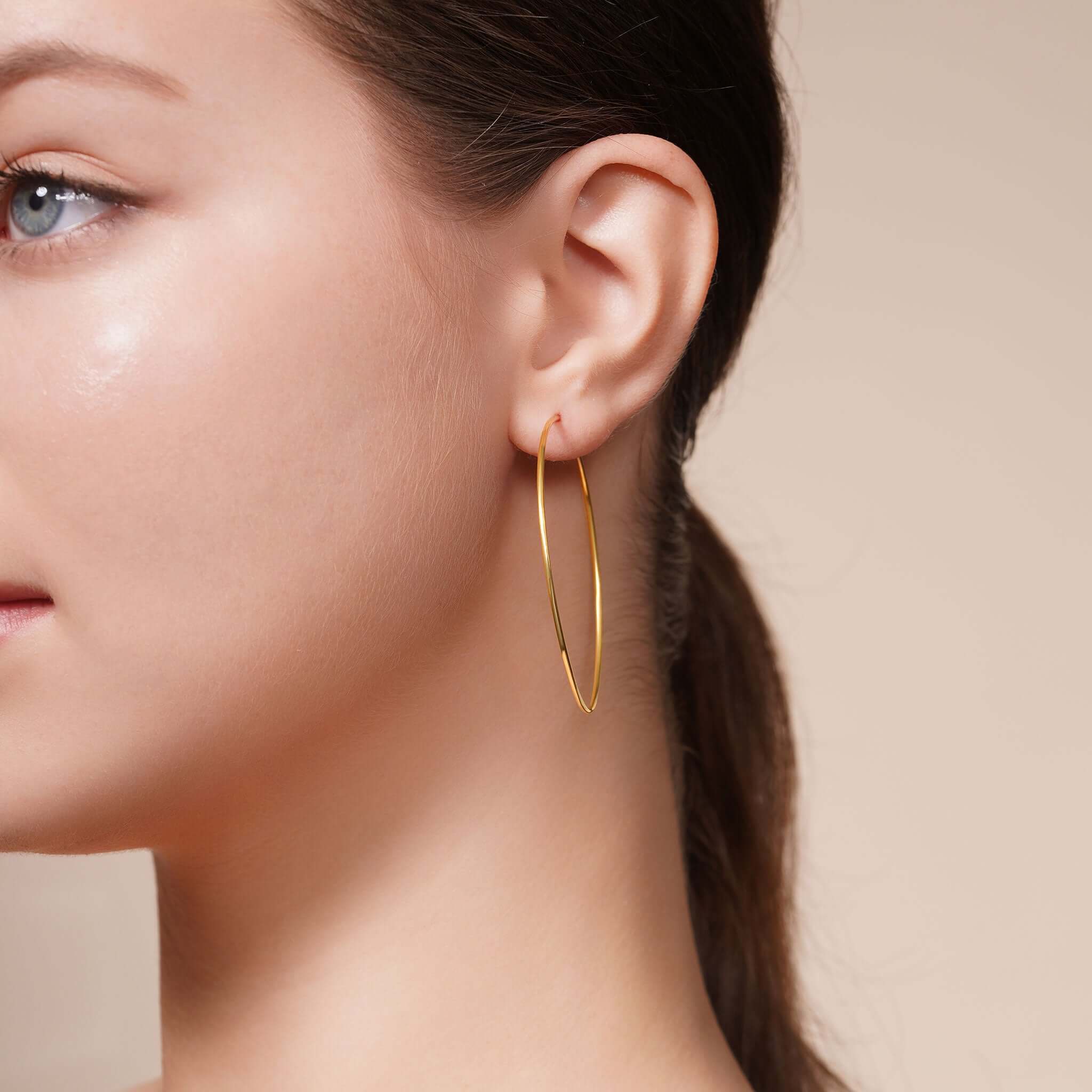 Model wearing Gold Endless Hoop Earrings showcasing timeless design and elegant style.