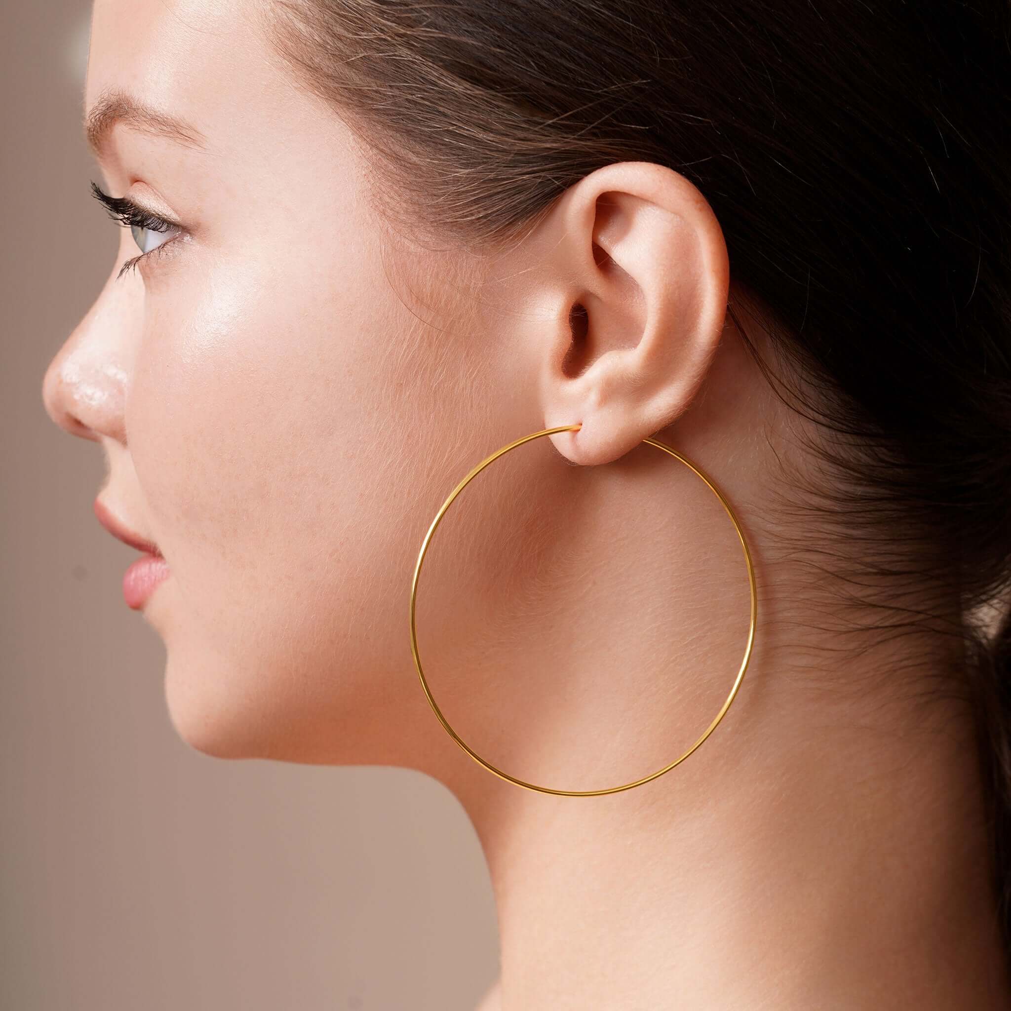 Gold Endless Hoop Earrings worn by a model, showcasing their elegant design and timeless appeal.