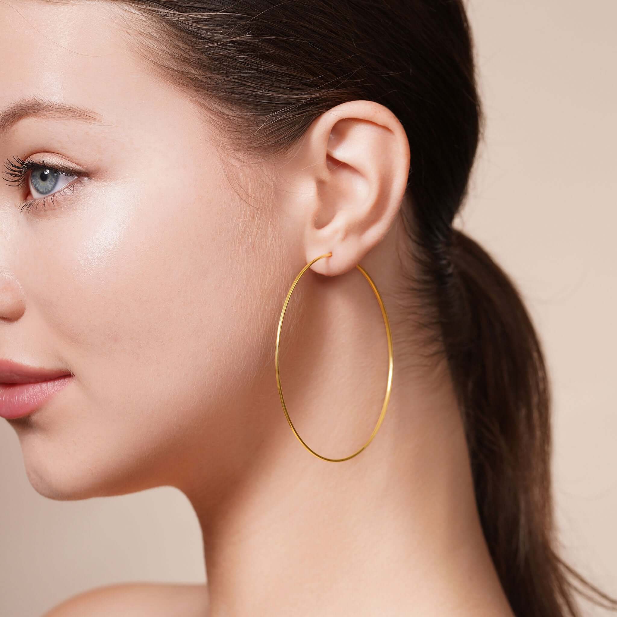 Model showcasing Gold Endless Hoop Earrings, highlighting their elegant design and shiny finish.