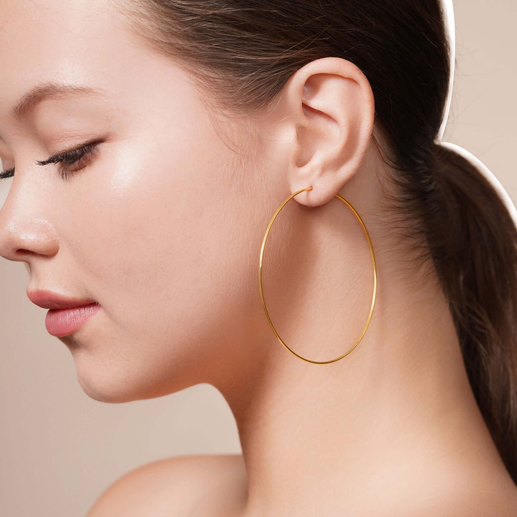 Model wearing Gold Endless Hoop Earrings, showcasing timeless elegance and high-quality gold finish.