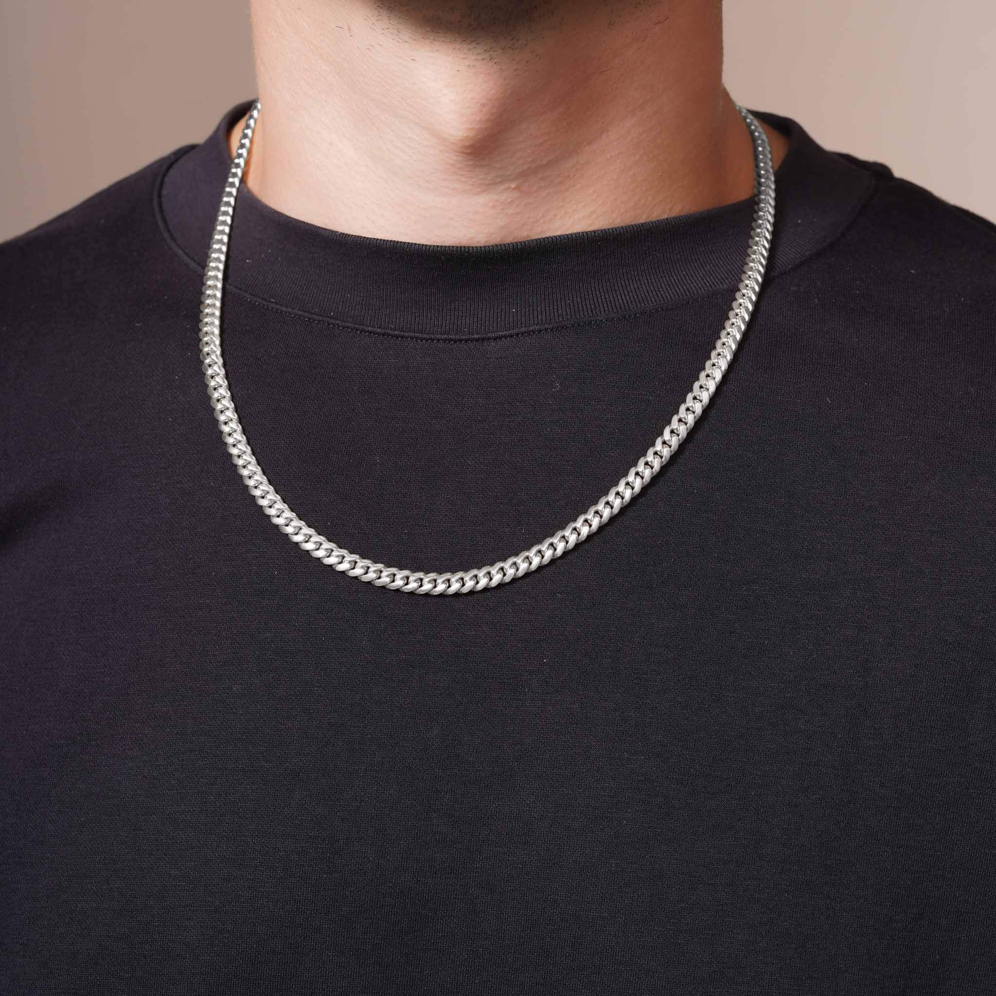 Men's White Gold Miami Cuban Chain elegantly displayed on a model, showcasing its bold 14k solid white gold design.
