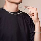 Men's White Gold Miami Cuban Chain worn by a man, showcasing its bold design and high-quality 14k solid white gold.