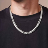 Men's White Gold Miami Cuban Chain worn on a man's neck, showcasing its bold and chunky design.