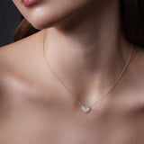 Close-up of a woman wearing an Engraved Heart Necklace in silver, showcasing its intricate design and elegance.