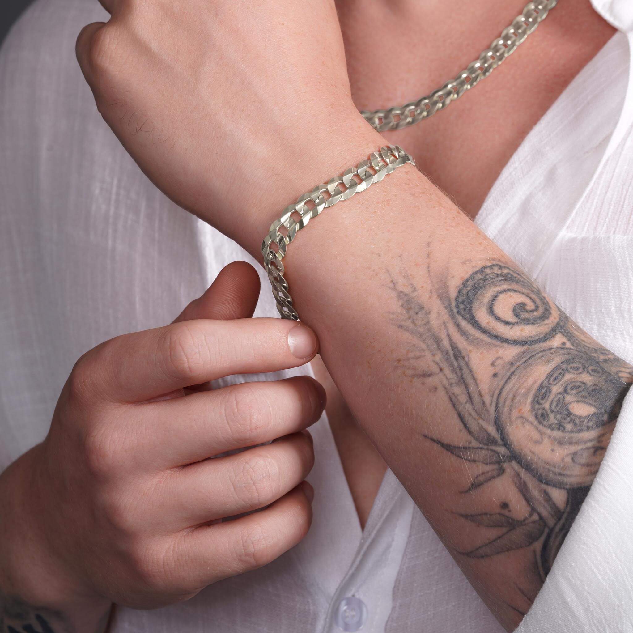 Men's solid gold curb bracelet in 14K gold, worn on wrist, showcasing classic design and expert craftsmanship.