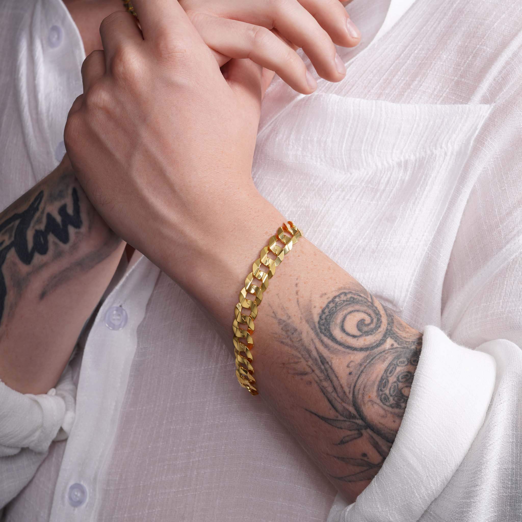 Men's solid gold curb bracelet on a wrist, showcasing elegant design and bold craftsmanship, ideal for daily wear.