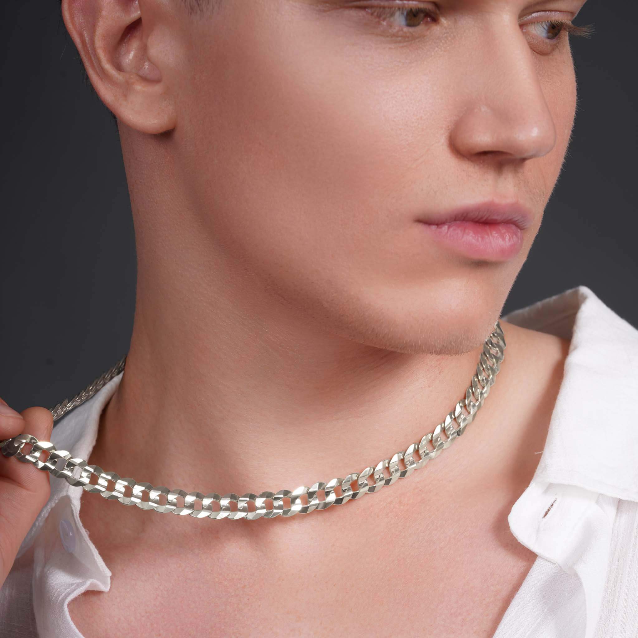 Model showcasing a Men's Solid Gold Curb Chain, highlighting its sleek design and precision craftsmanship.