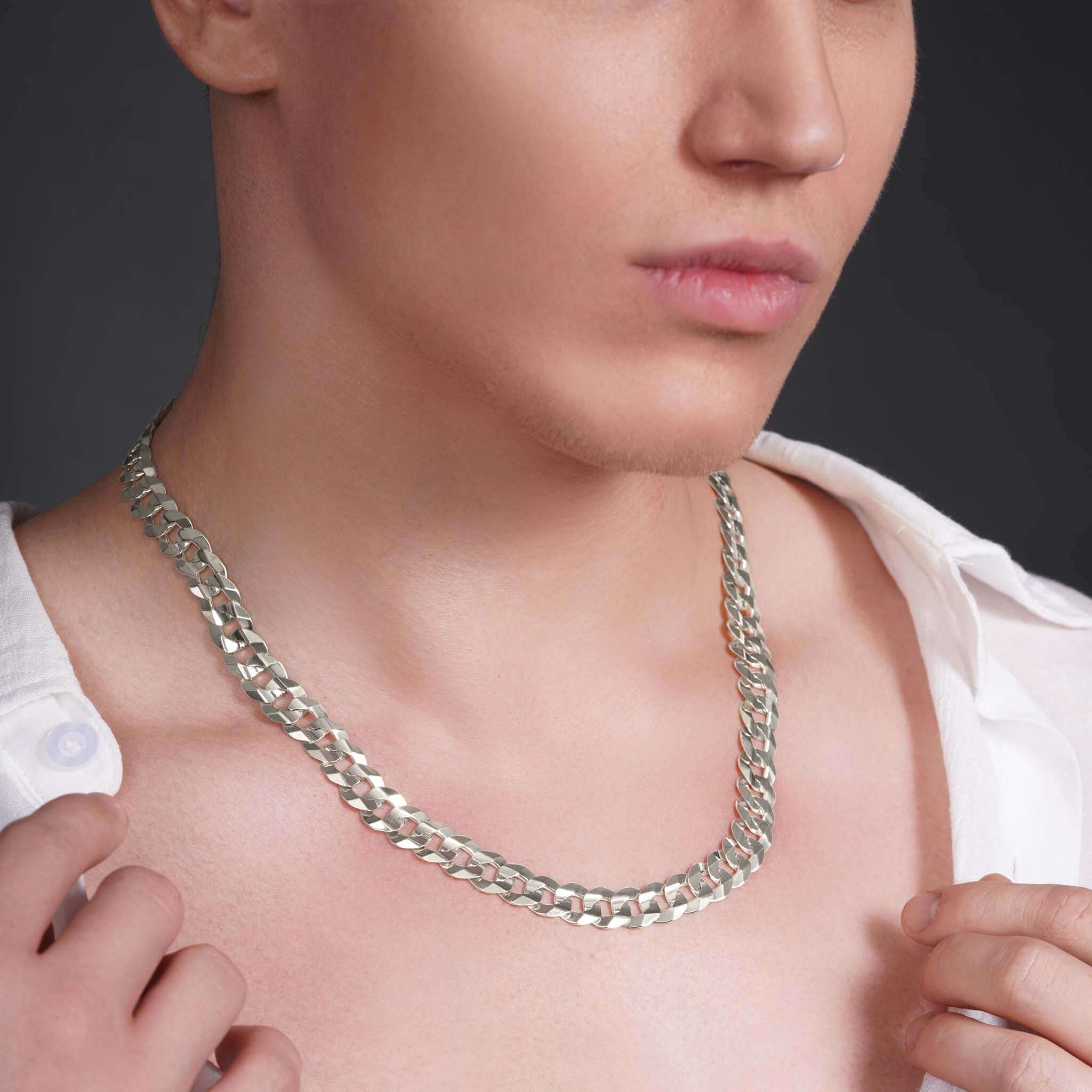 Men wearing a stunning solid gold curb chain necklace, showcasing its elegance and shine against bare skin.