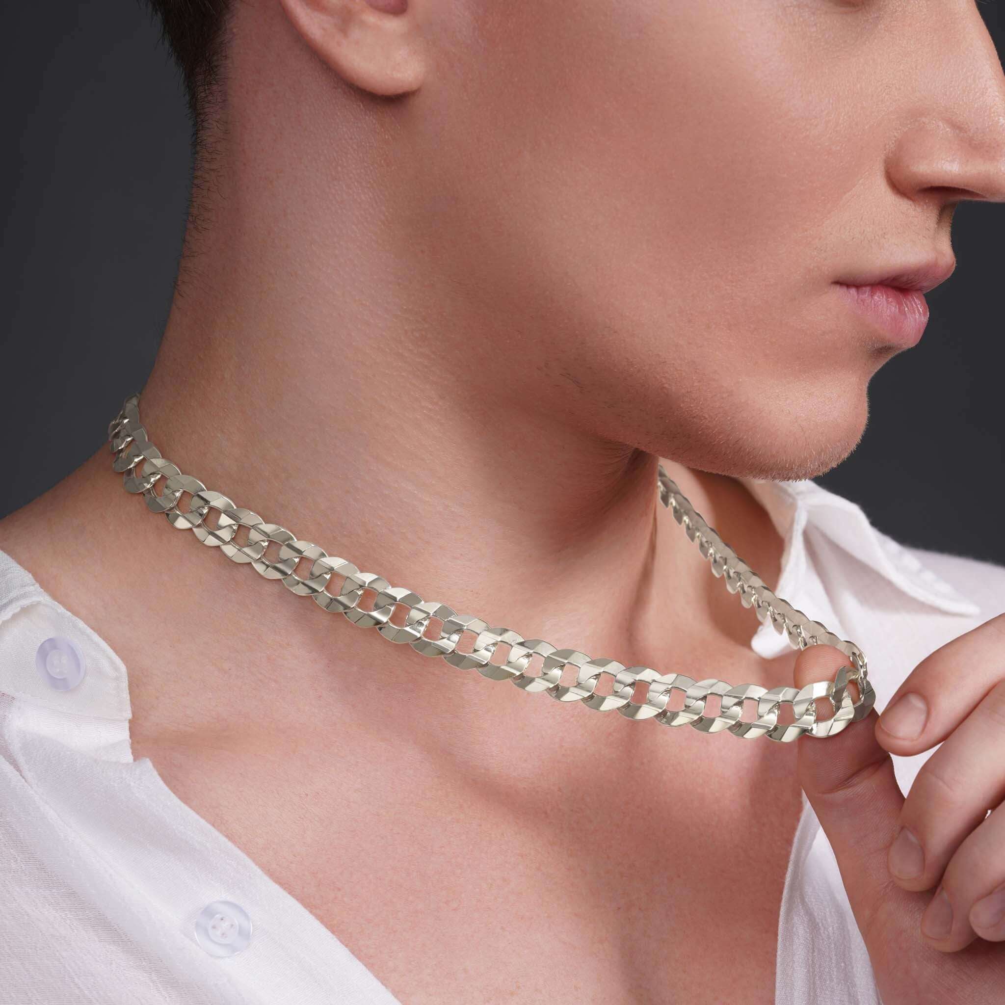 Man wearing a men's solid gold curb chain, showcasing the elegant design and smooth links.