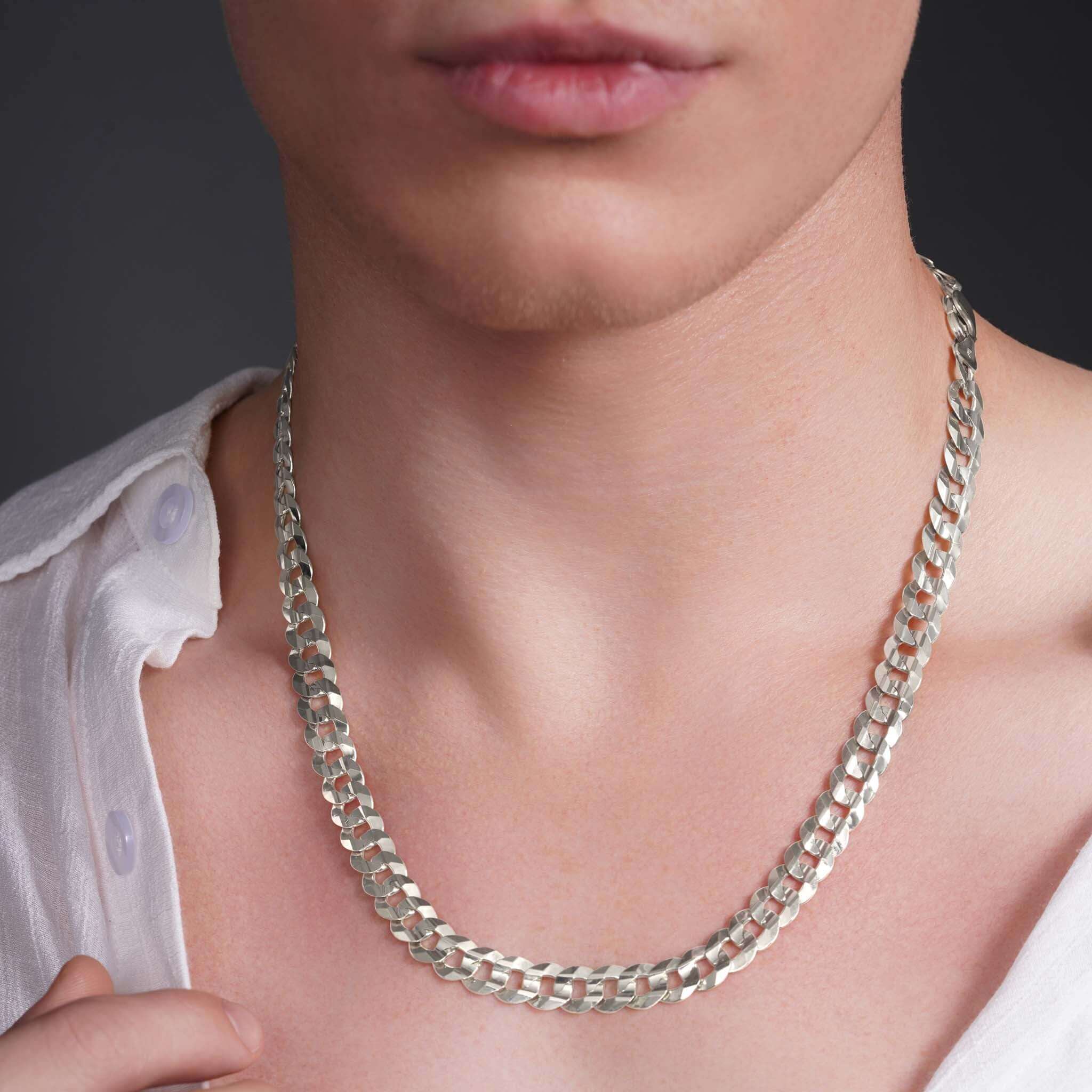 Men's solid gold curb chain necklace in white gold, showcasing interlocking links on a model's neck.