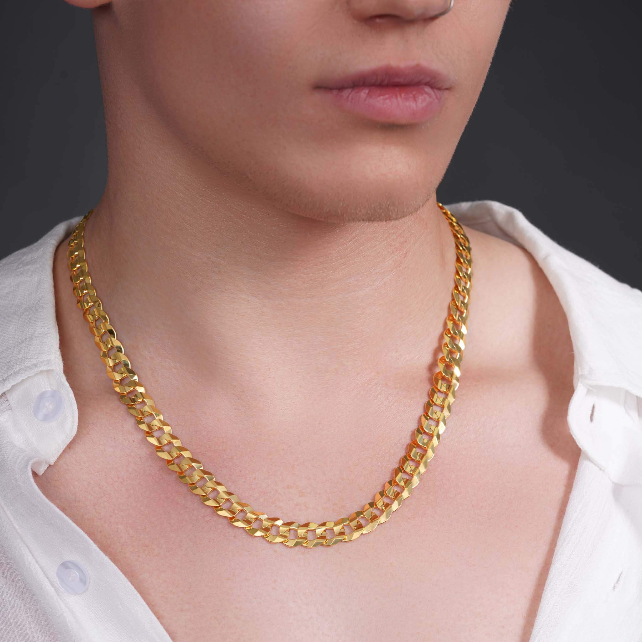 Men's solid gold curb chain necklace displayed on model, featuring interconnected flattened links.