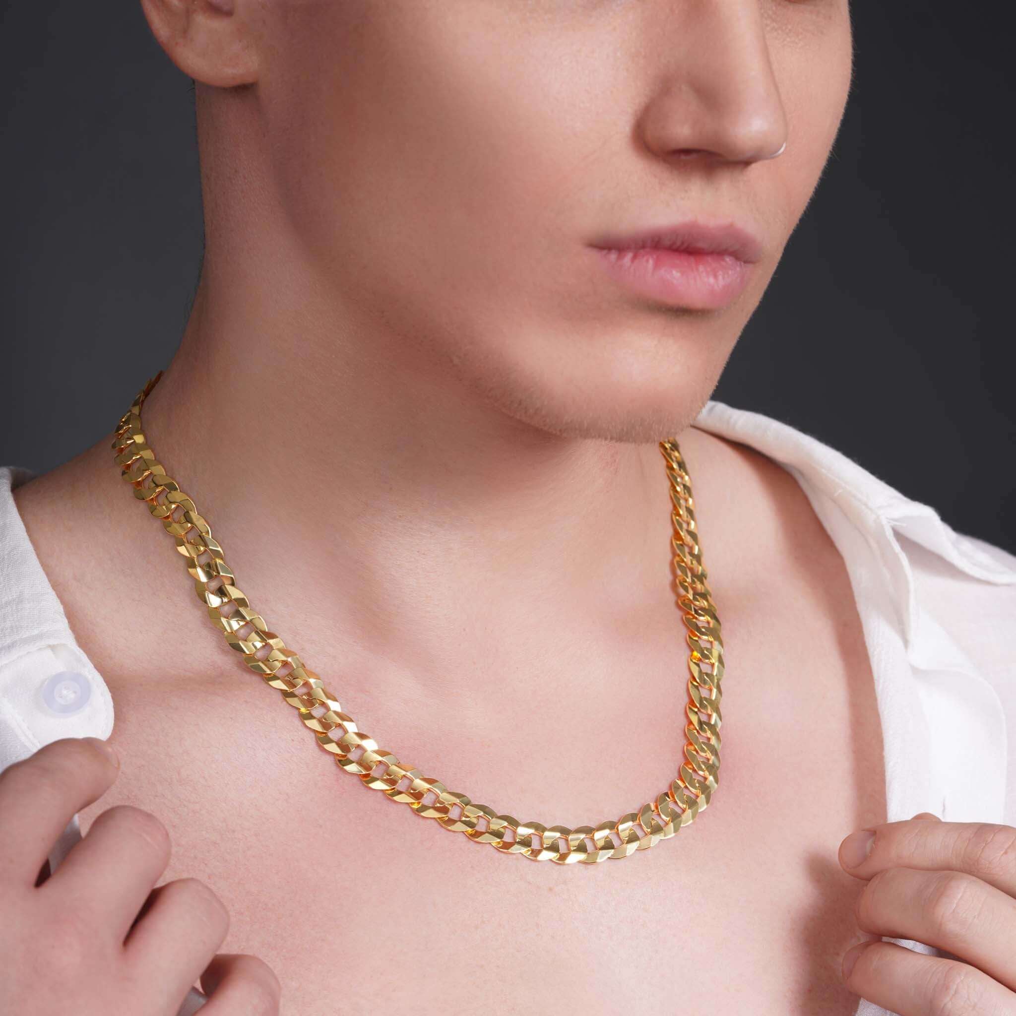 Men's solid gold curb chain necklace displayed on a model, showcasing its sleek design and craftsmanship.