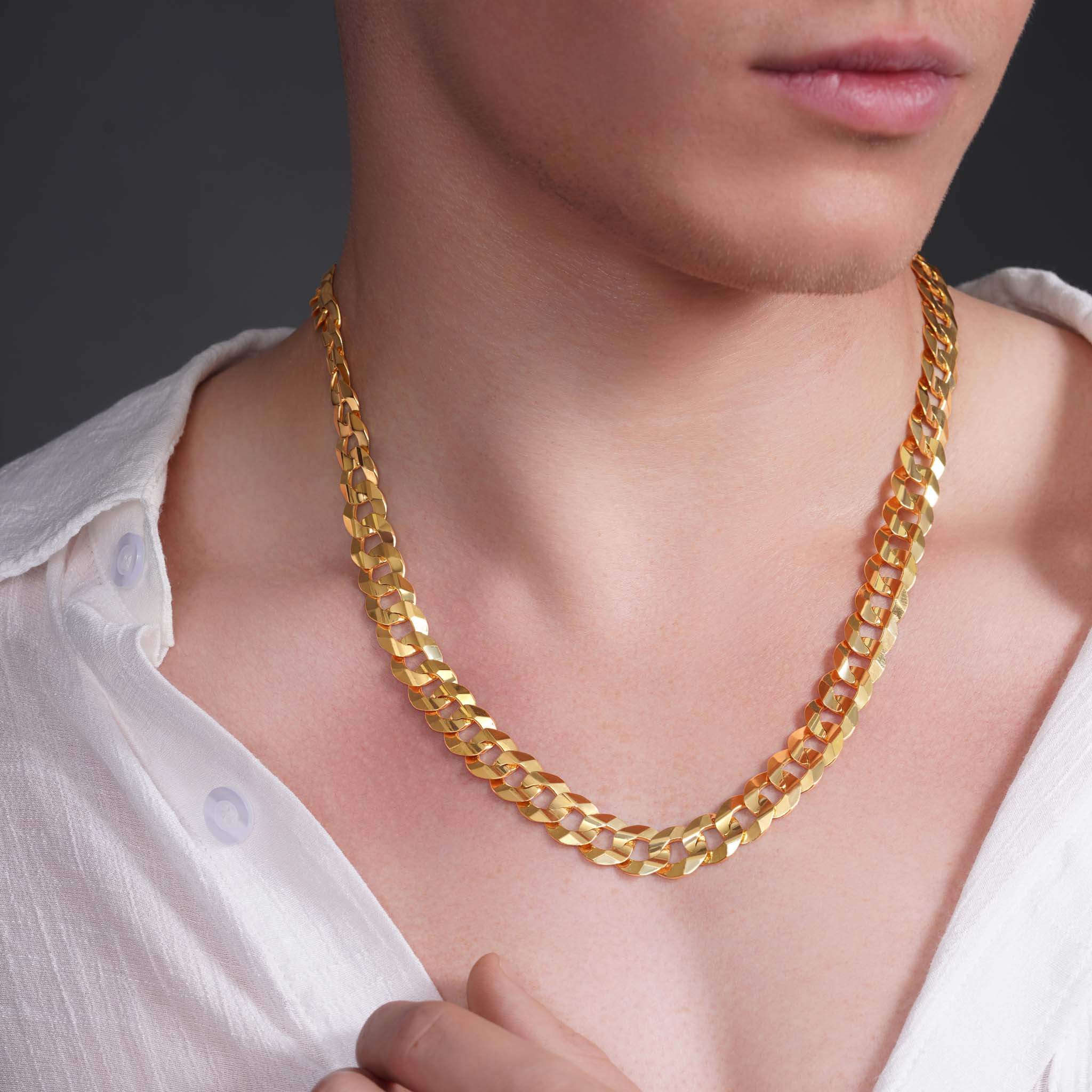 Men's solid gold curb chain necklace worn by a male model, showcasing its shiny interlocking links.