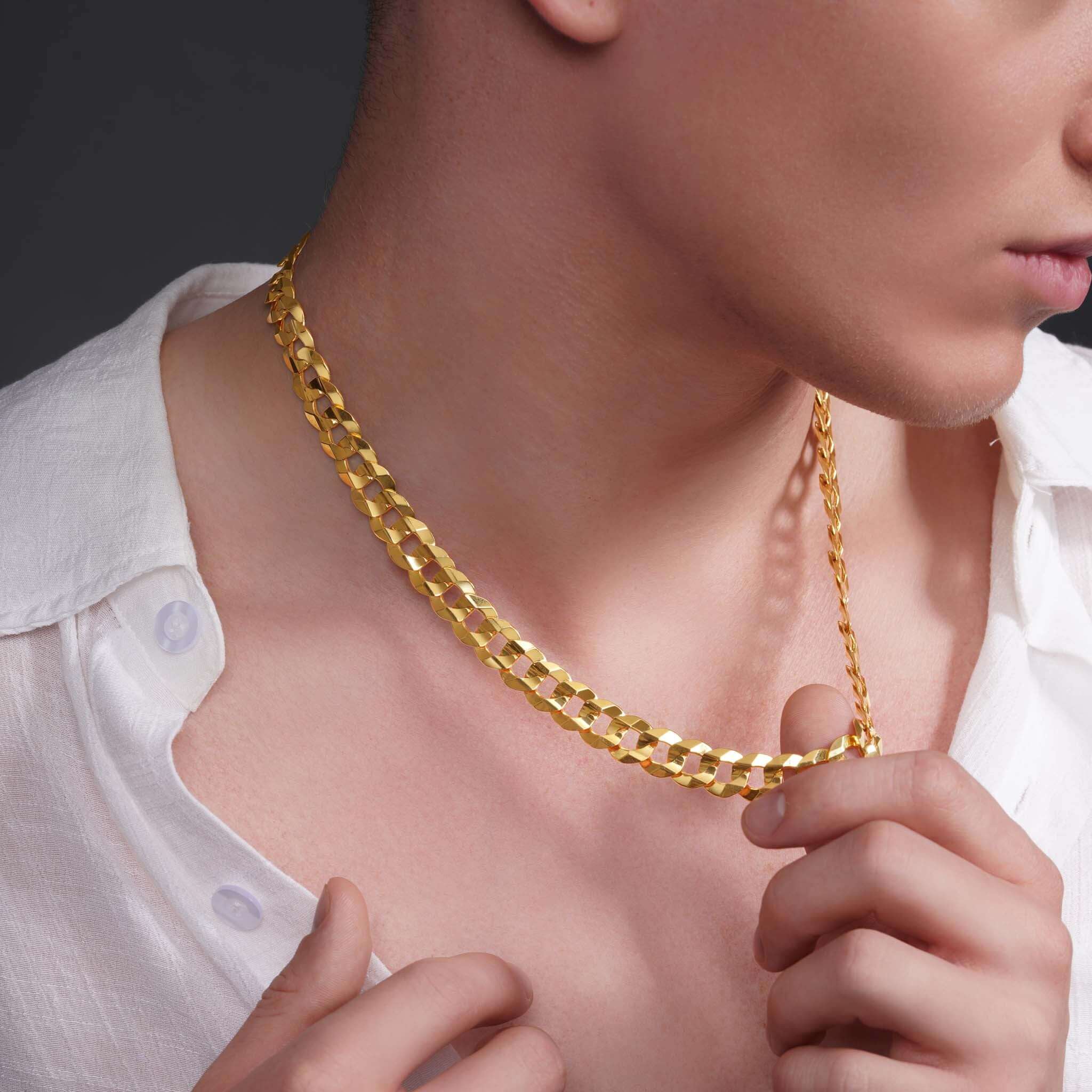 Men's solid gold curb chain on model, showcasing the shiny 14k gold links and bold, stylish design.