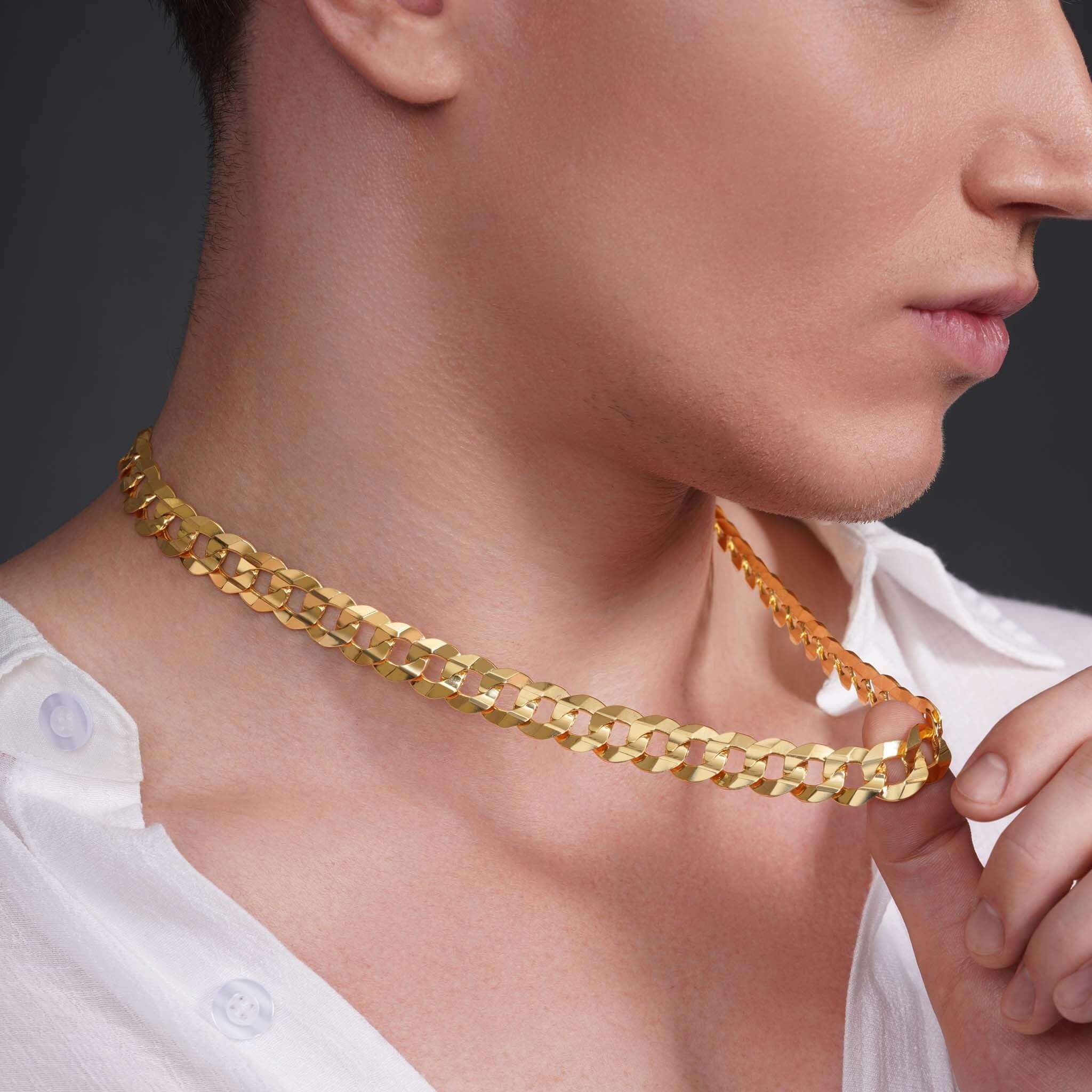 Close-up of a man wearing a 14k solid gold curb chain elegantly draped around his neck.