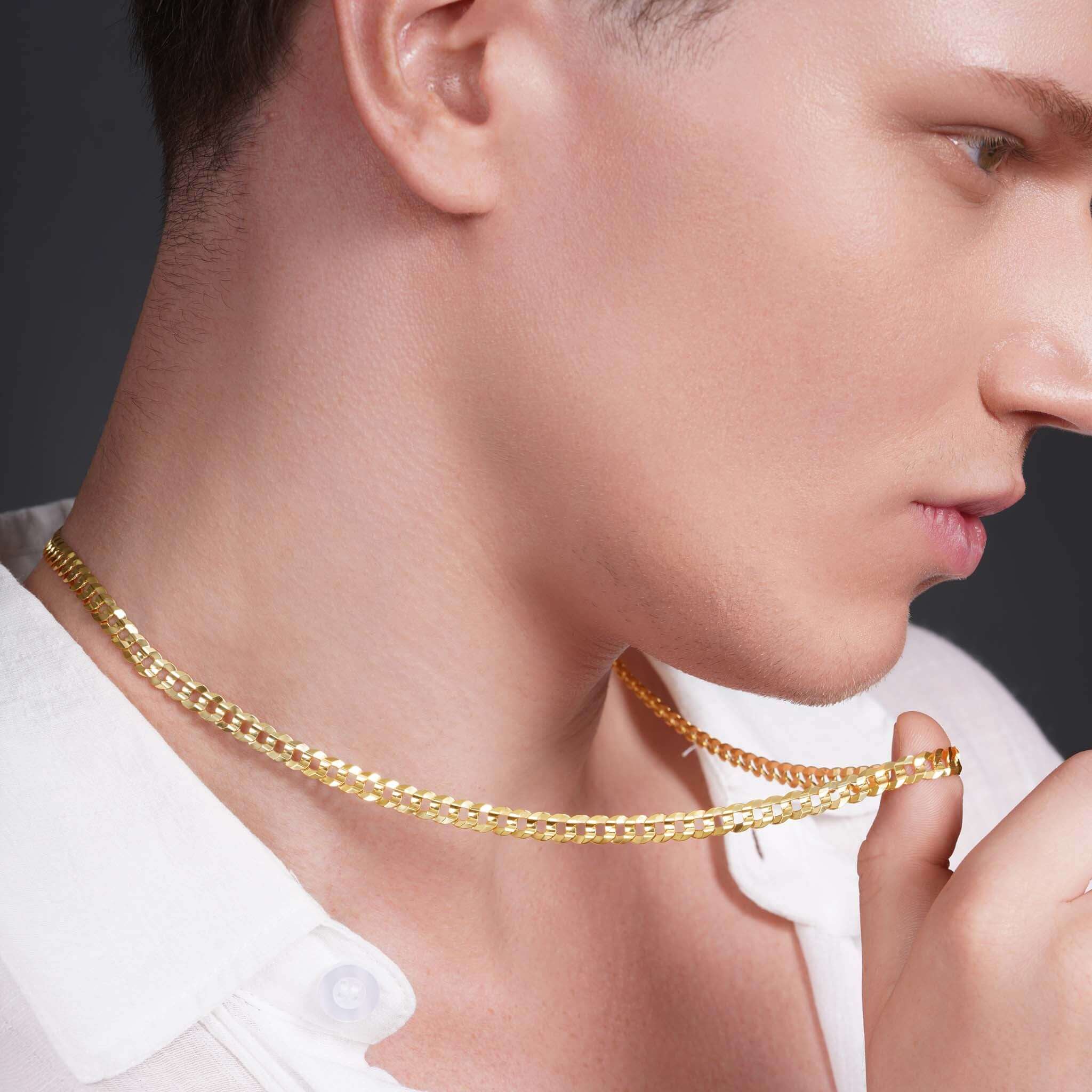 Close-up of a man wearing a Men's Solid Gold Curb Chain, showcasing its elegance and shine.