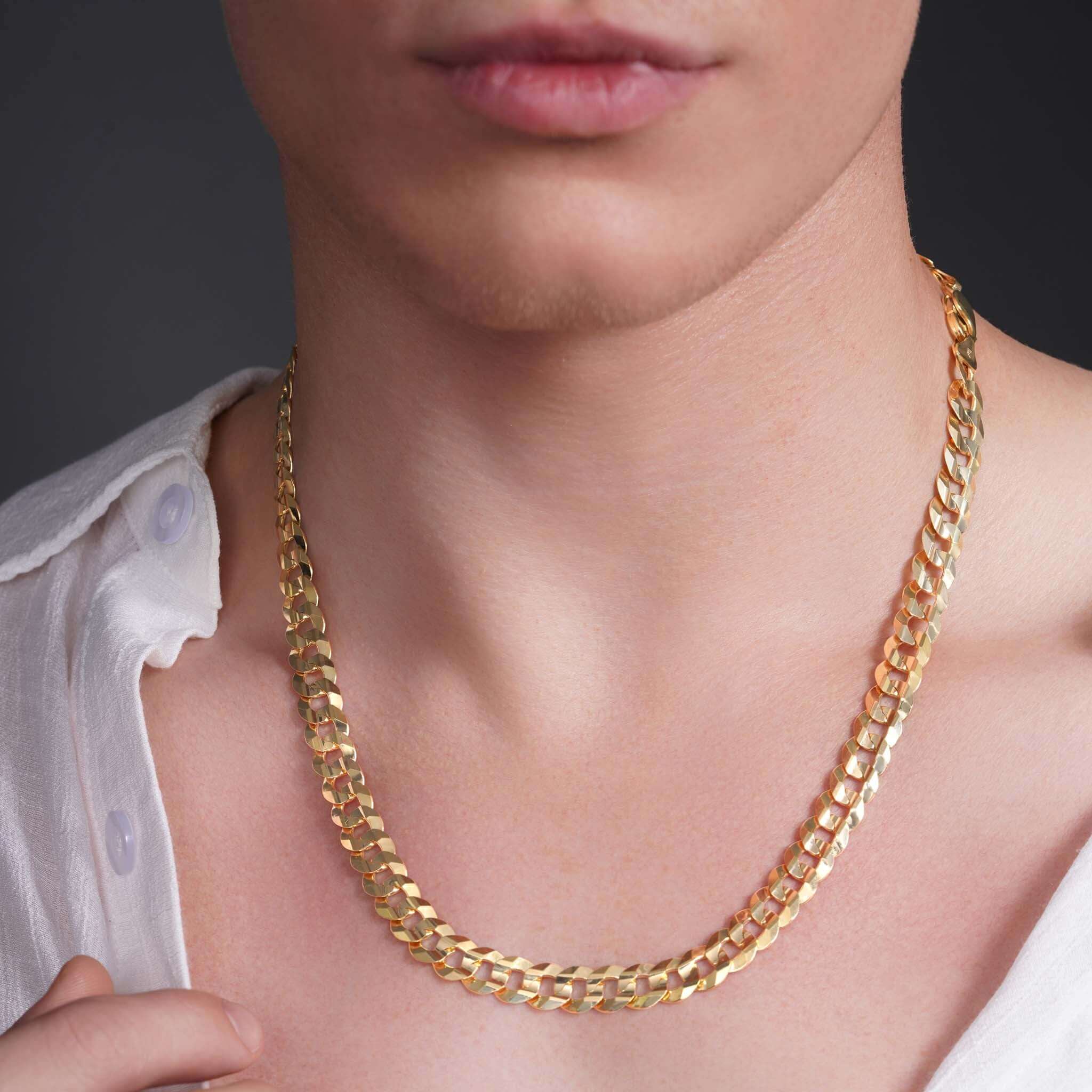 Close-up of a man wearing a men's solid gold curb chain necklace, showcasing its elegant design and shine.