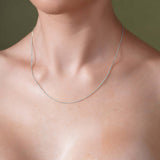 Close-up of a model wearing a Diamond Cut Franco Chain in silver against a neutral background.