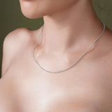 Close-up of a woman wearing a Diamond Cut Franco Chain in silver, showcasing its sparkle and elegance.