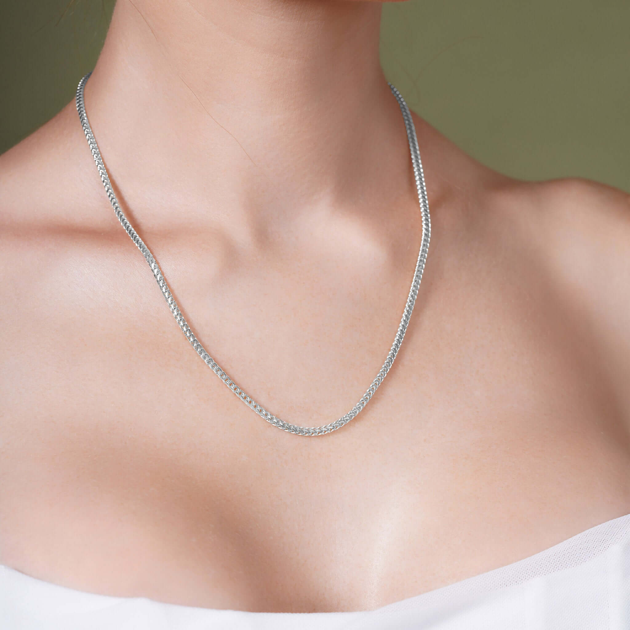 Diamond Cut Franco Chain in solid white gold worn on a model's neckline, showcasing sparkling diamond-cut facets.