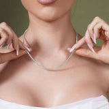 Model showcasing a Diamond Cut Franco Chain, highlighting its sparkle and elegance against a soft green background.