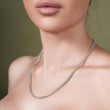 Woman wearing a Diamond Cut Franco Chain made of 14k solid white gold with a sparkling surface.