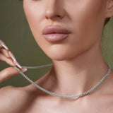 Model showcasing the Diamond Cut Franco Chain, a sparkling 14k gold chain around her neck.