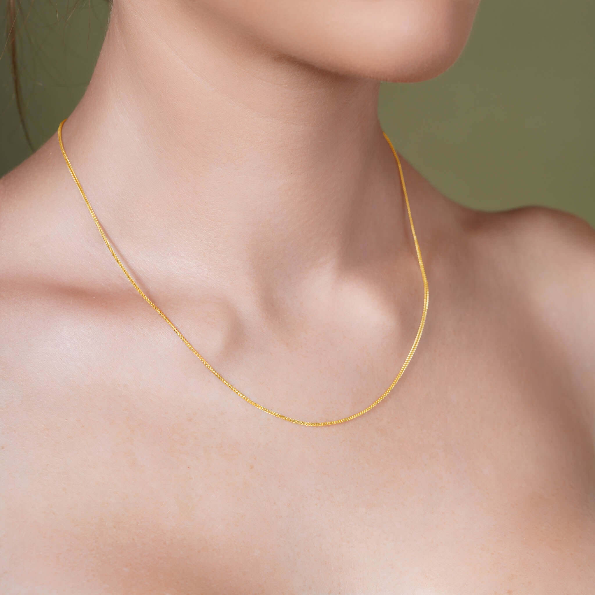 Diamond Cut Franco Chain worn on a model, showcasing its elegance and sparkle in solid yellow gold.