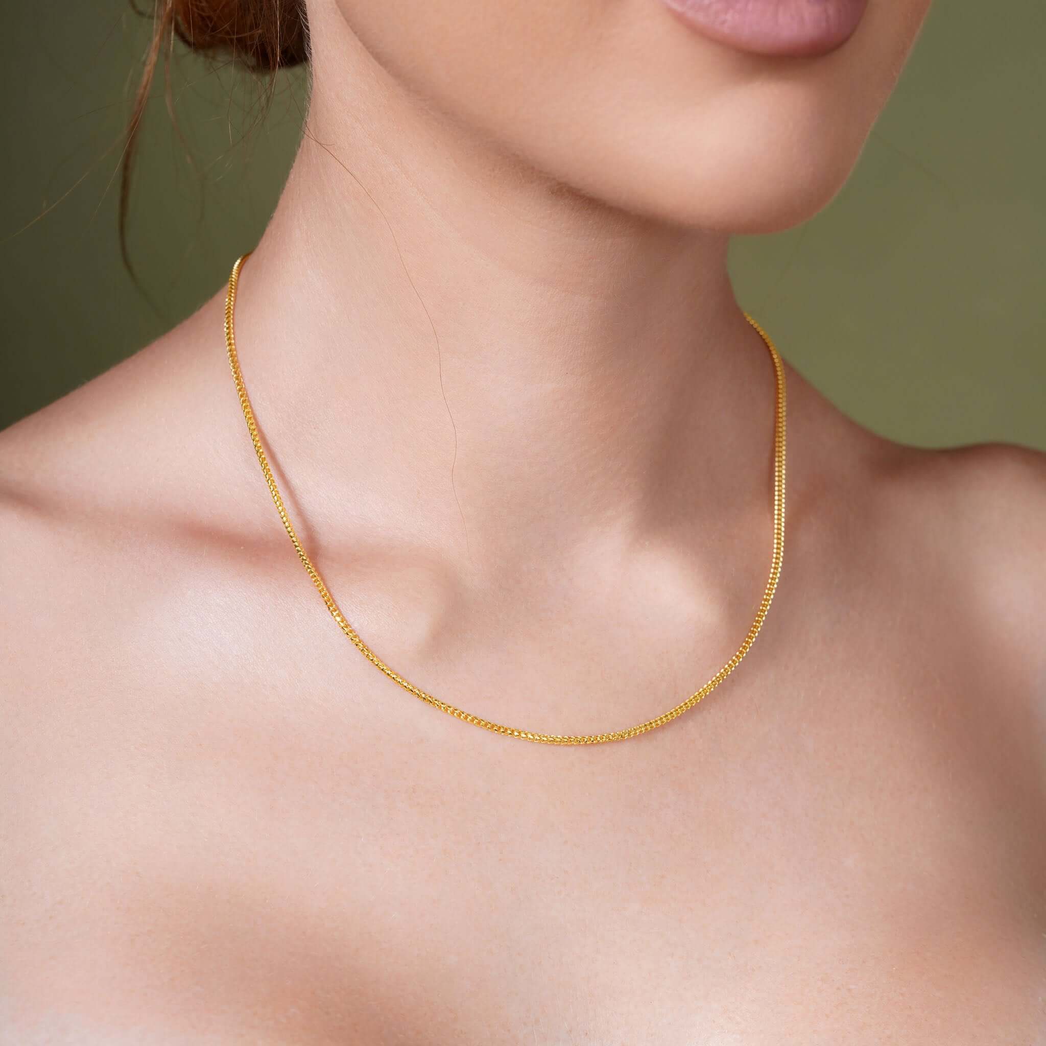 Diamond Cut Franco Chain displayed on a model, showcasing its sparkling design in solid gold.