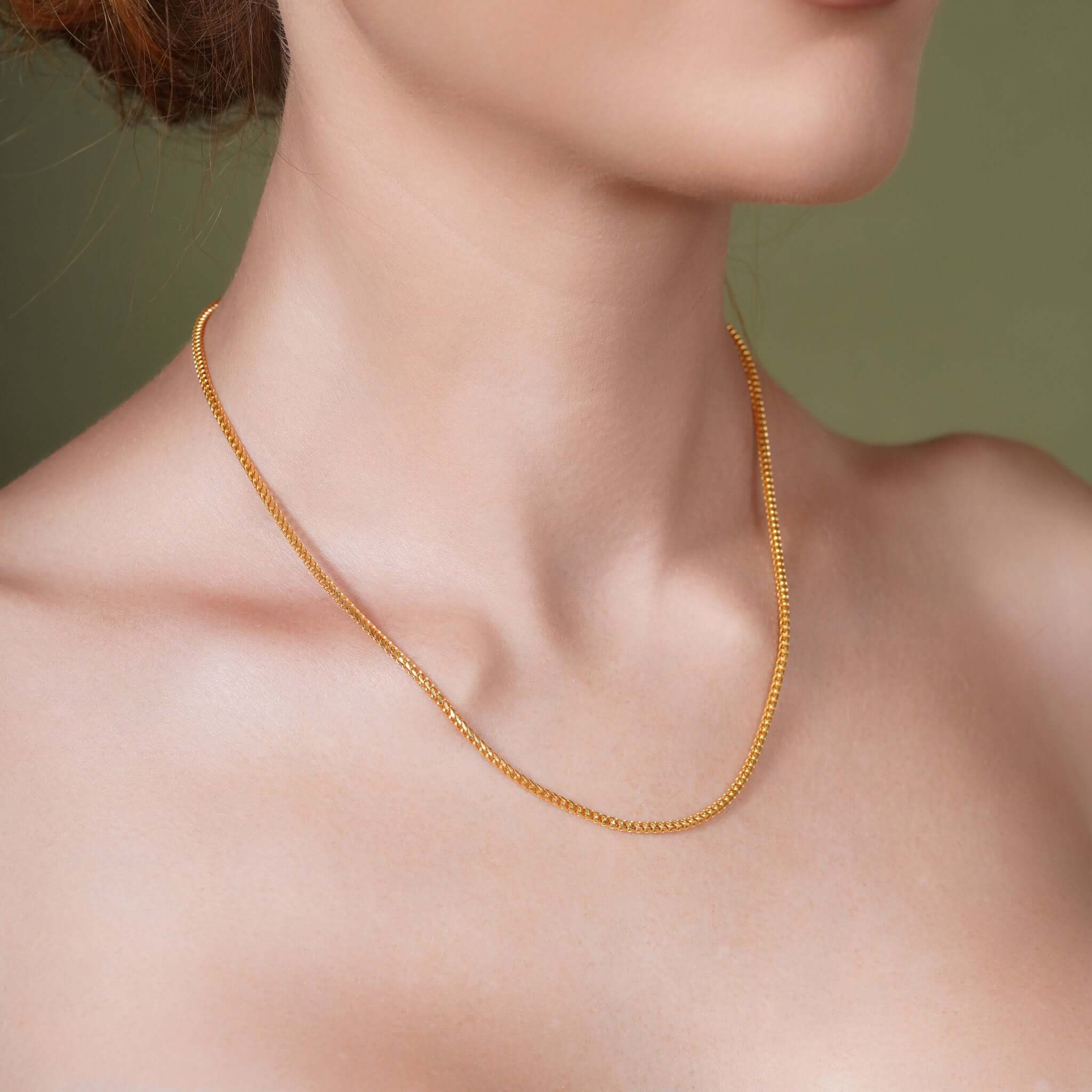 Diamond Cut Franco Chain worn by a woman, showcasing its radiant gold design.