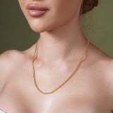 Woman wearing a stunning Diamond Cut Franco Chain made of 14k solid yellow gold.