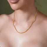 Franco Gold Chain worn by a model, showcasing its sleek design and luxurious 14k gold finish.