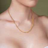 Franco Gold Chain showcased on a model's neck, highlighting the sleek design and 14k gold craftsmanship.