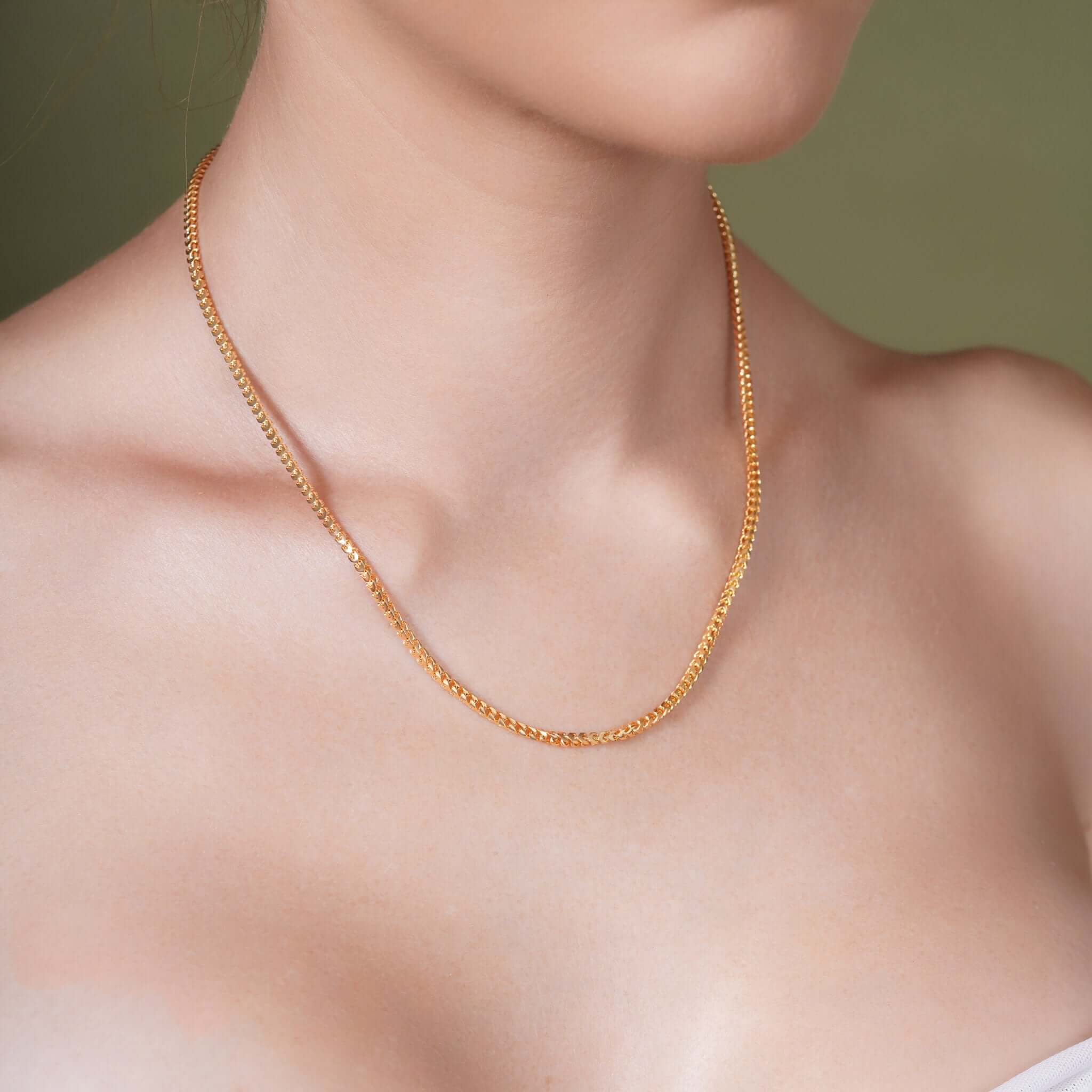 Franco Gold Chain showcased on a model's neck, highlighting the sleek design and 14k gold craftsmanship.