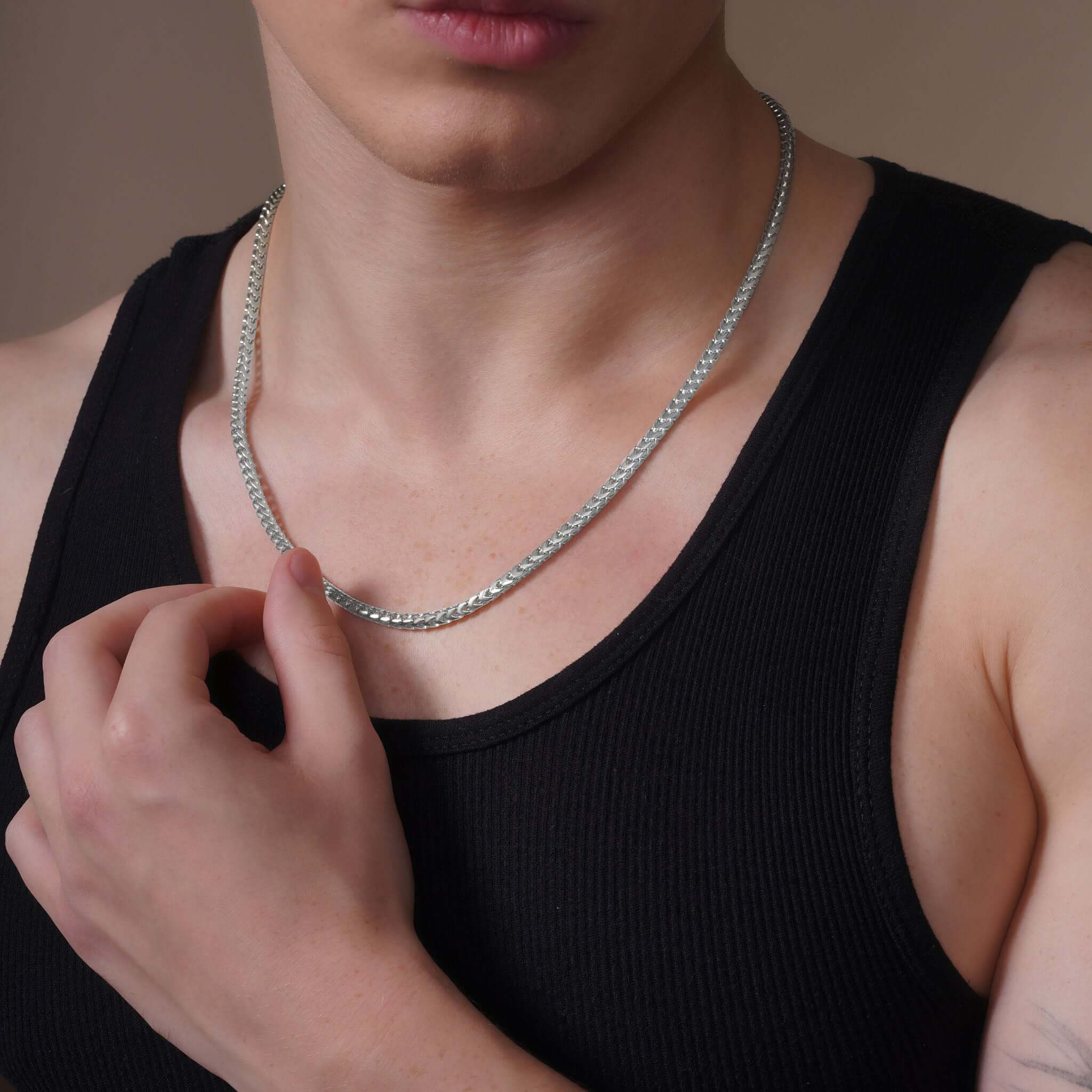 Men's Franco Gold Chain worn by a model, showcasing its sleek and stylish design in 14k gold.