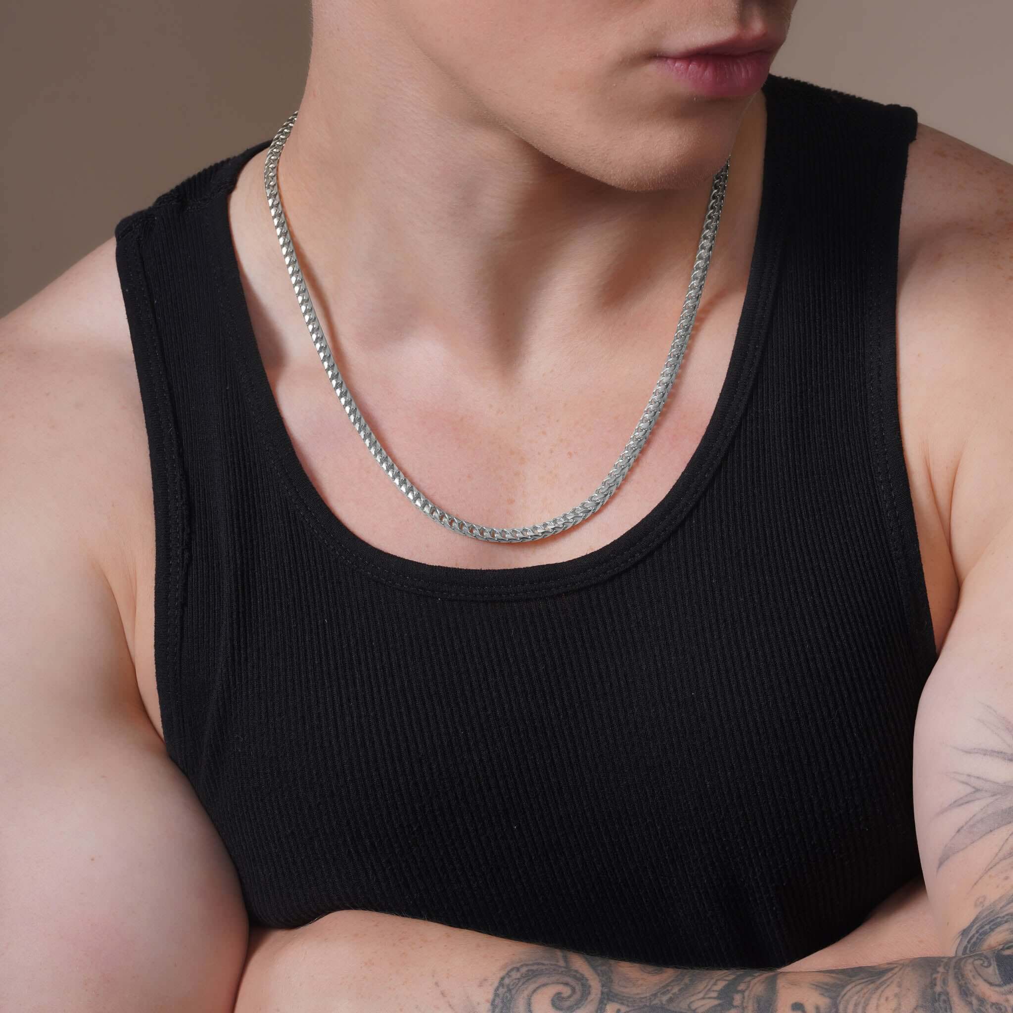 Men's Franco Gold Chain worn by a man in a black tank top, showcasing its sleek design and stylish appeal.