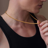 Close-up of a man wearing a stylish Men's Franco Gold Chain, showcasing its sleek design and elegant shine.