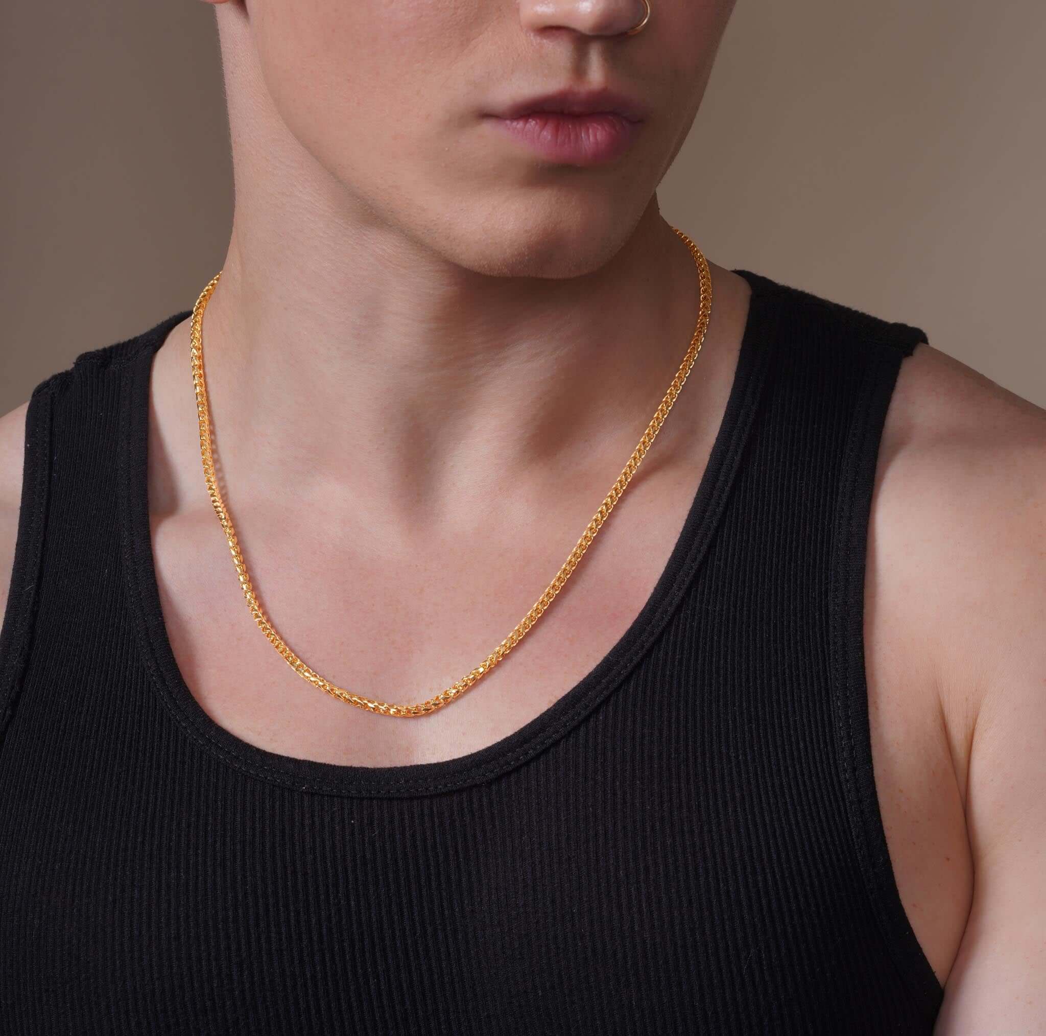 Men's Diamond Cut Franco Gold Chain worn by a model with a sleek style and modern elegance.
