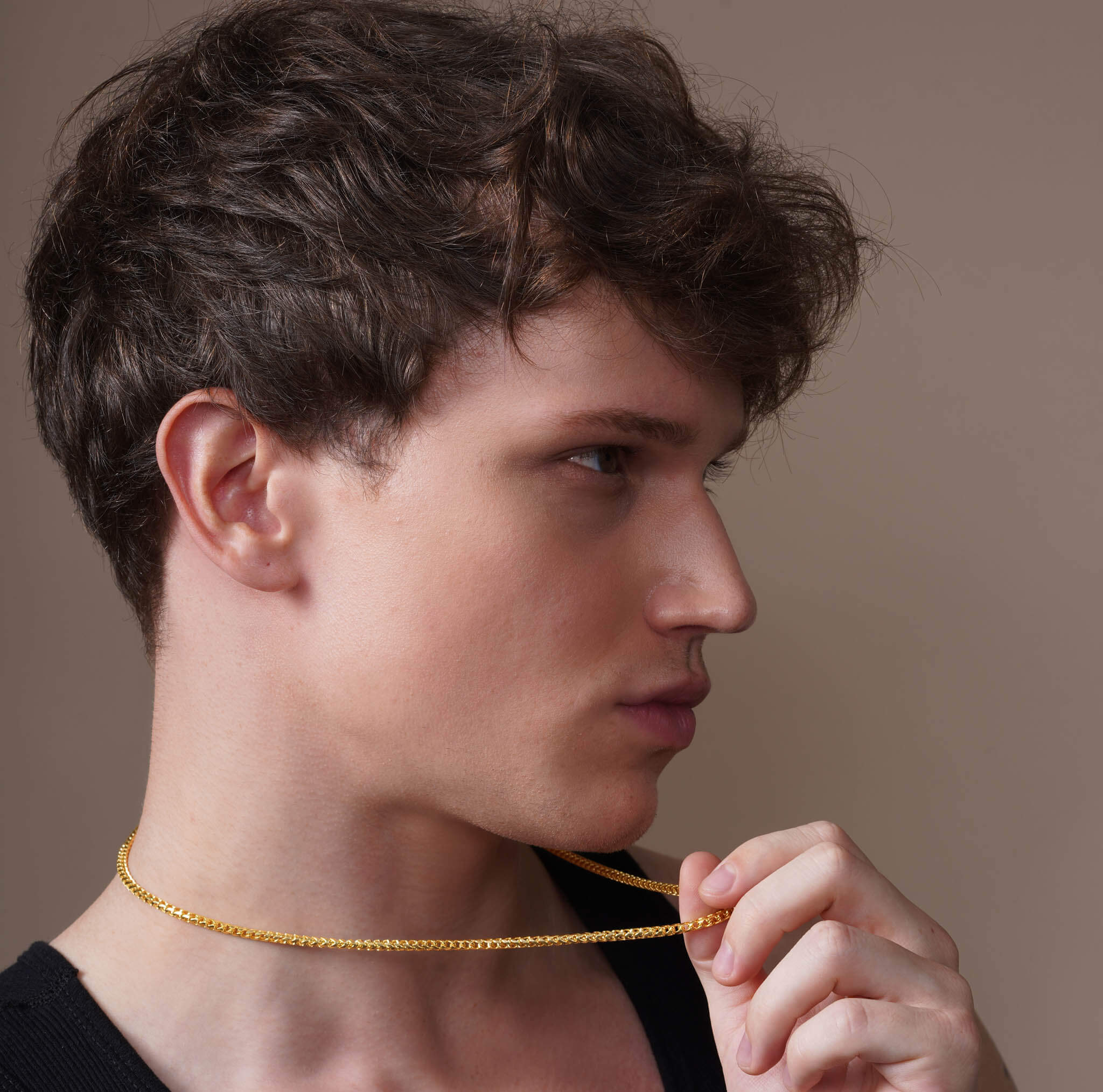 Men's Diamond Cut Franco Gold Chain worn by a young man, showing its sleek and sophisticated design.
