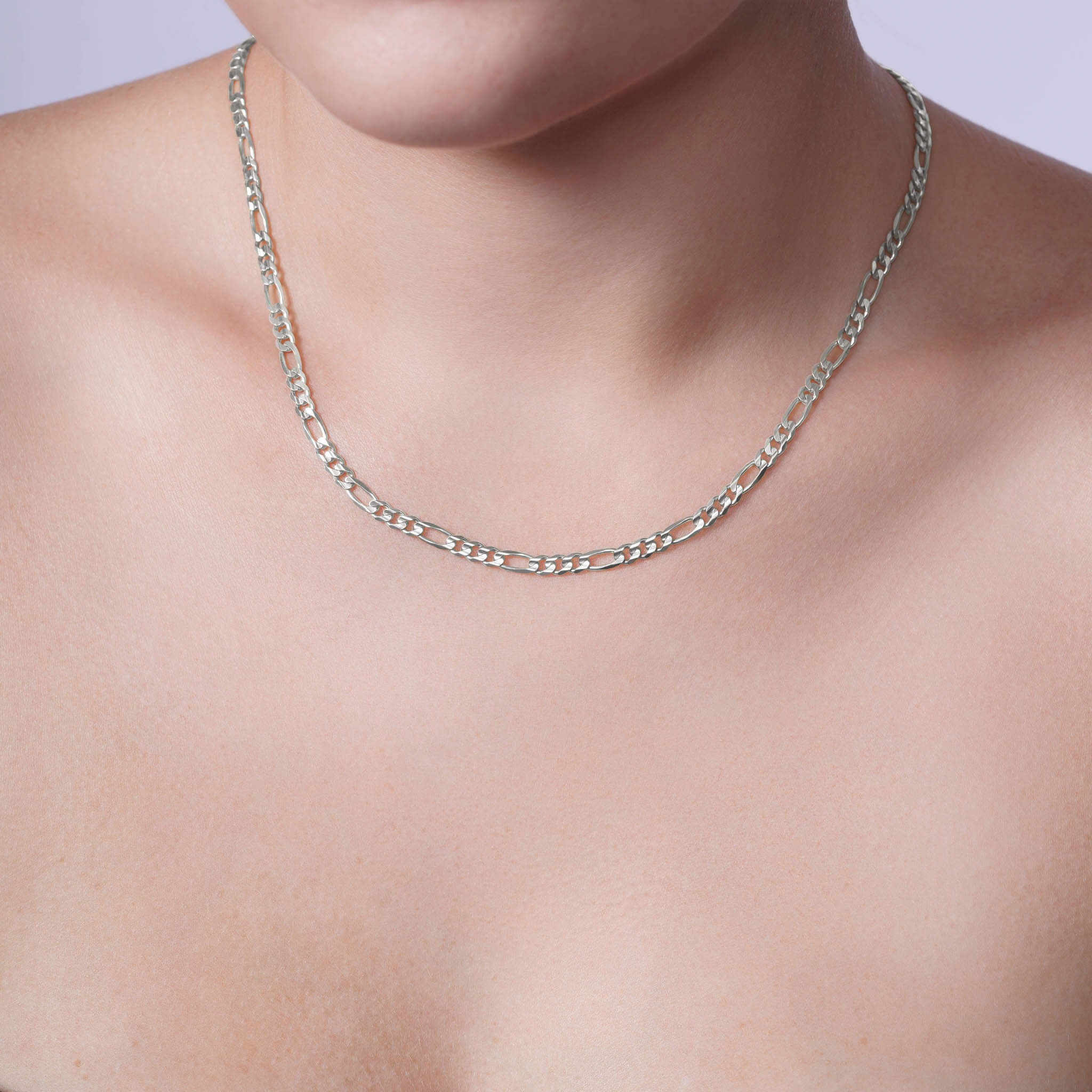 Elegant Figaro Gold Chain worn around the neck, showcasing a timeless design in durable white gold.