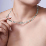 Figaro Gold Chain displayed elegantly on a woman's neck, showcasing its classic design and craftsmanship.