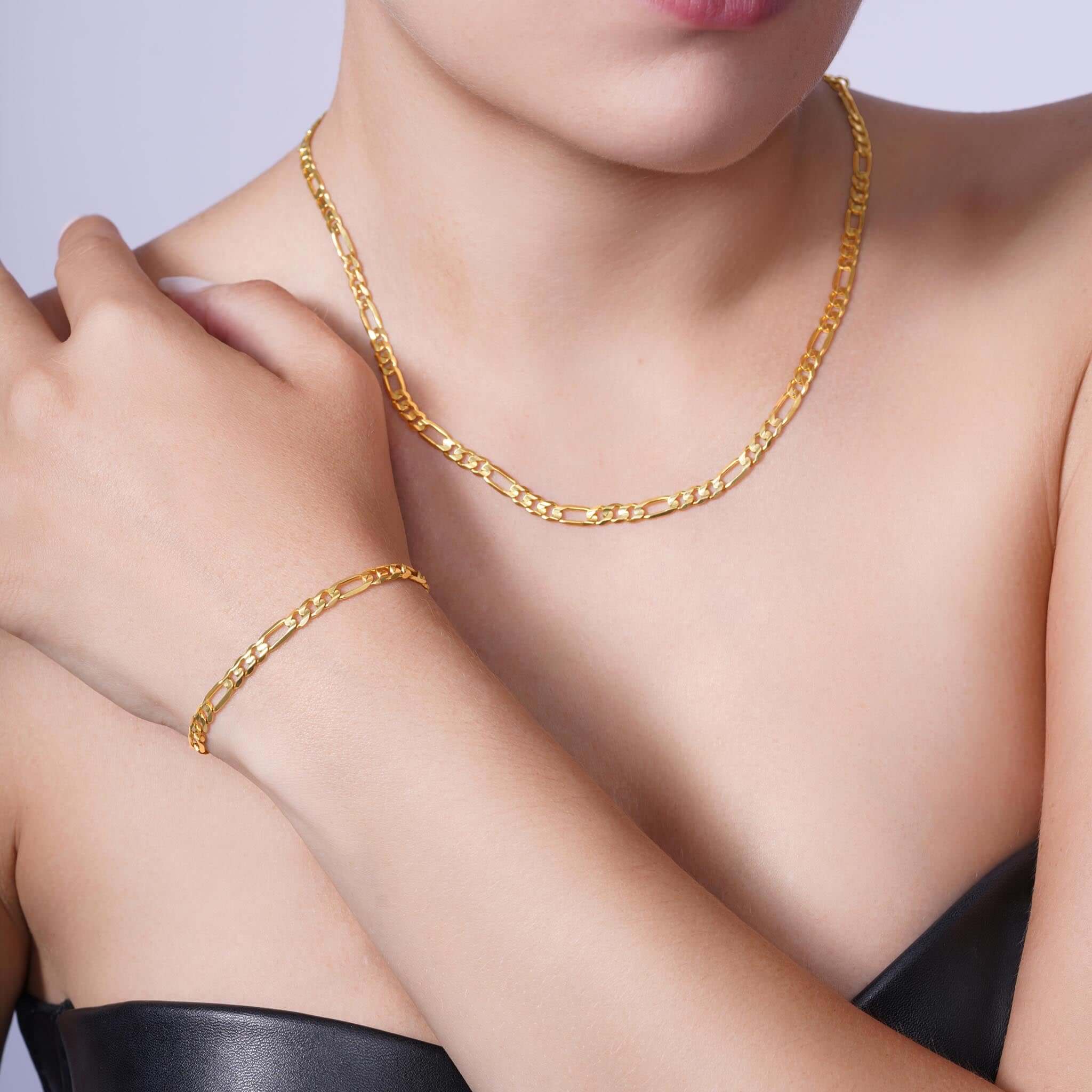 Figaro Gold Chain worn by a woman, showcasing its elegant design and versatile style in 14k gold.