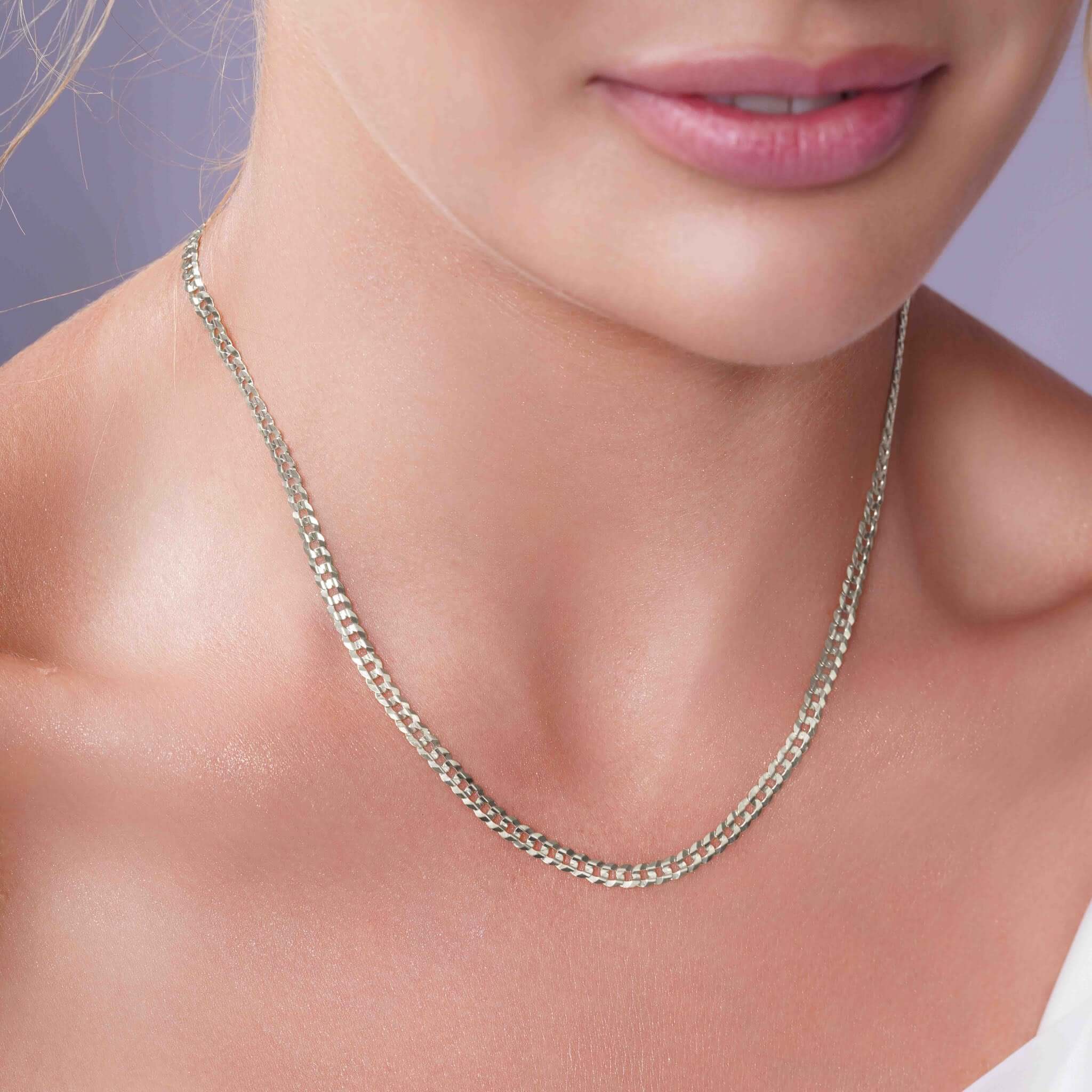 Curb Silver Chain elegantly showcased on a woman's neck, highlighting its timeless design and sophisticated appeal.